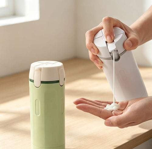 4-in-1 travel dispenser bottle showing dispensing pumps close-up